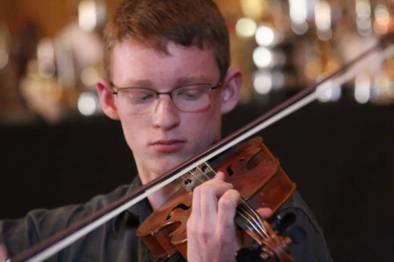 Young pianist at upright piano