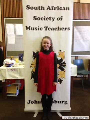 Young participant at SASMT banner